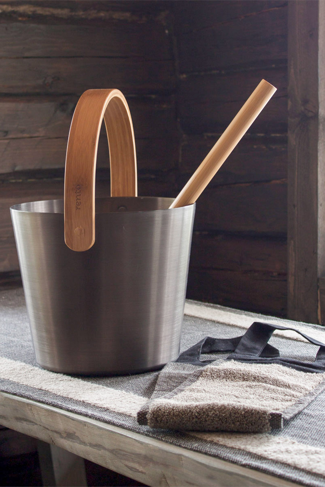 nomad cabin rento metal and wood sauna bucket and ladle on bench